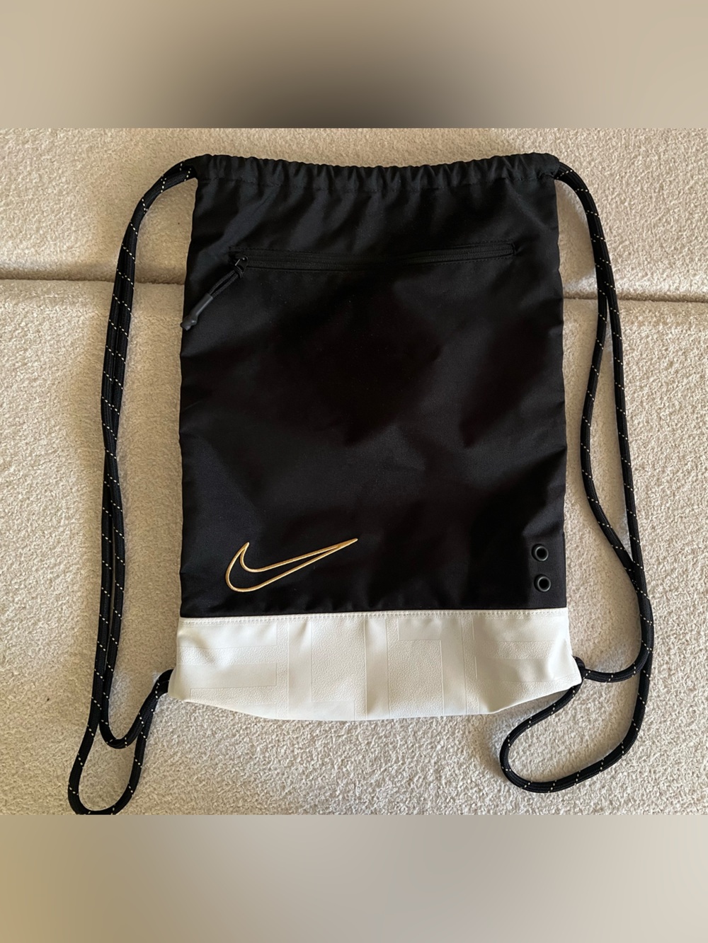 Nike Black and White Drawstring Backpack with Gold Swoosh Accent